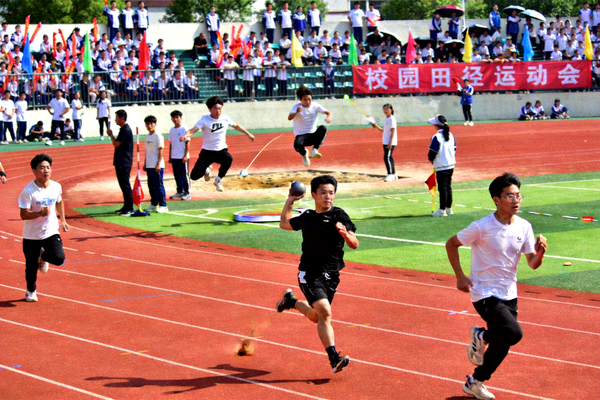校园体育比赛活动现场，学生们积极参与田径运动会